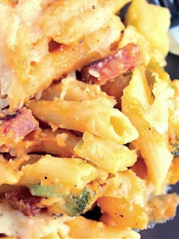 A closeup photo of Macaroni Ham and Cheese with penne pasta, ham, and broccoli.