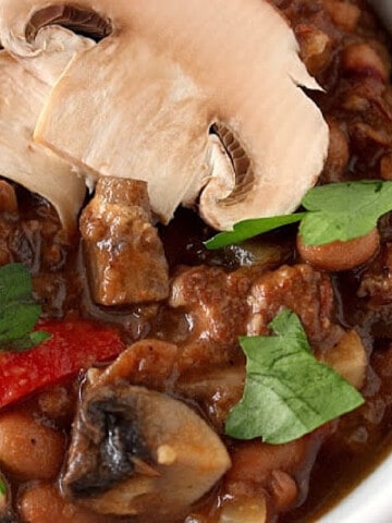 A Pot Roast and Portobello Stew with fresh mushrooms on top.