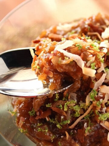 A closeup of a spoon with Caramelized Rice Pudding with Coconut and Lime.