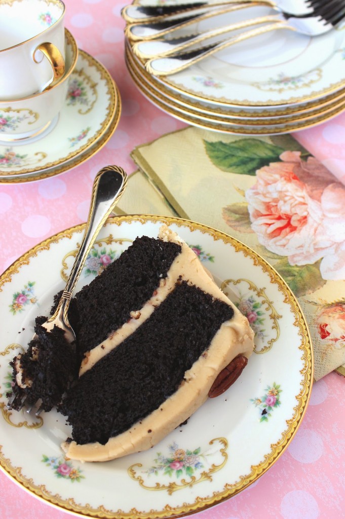 A slice of Chocolate Layer Cake with Caramel Frosting on a pretty plate.