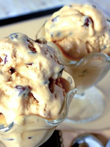 Two dishes of slightly melted Peanut Butter and Chocolate Chip Ice Cream.