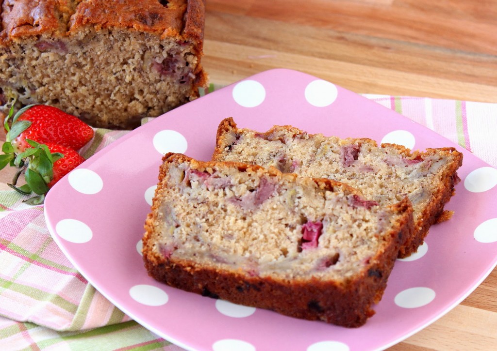 Two slices of Strawberry Rhubarb Banana Bread on a pink and white polka dot plate with a napkin.