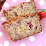 Two slices of Strawberry Rhubarb Bread with Bananas on a pink and while polka dot plate.