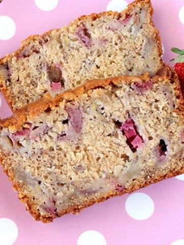 Two slices of Strawberry Rhubarb Bread with Bananas on a pink and while polka dot plate.