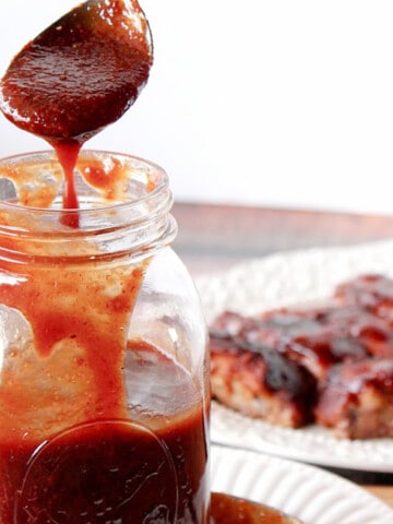 A spoon and mason jar with Sweet Asian Chili Sauce.