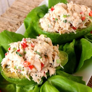 Two Crab Stuffed Avocados on lettuce leaves.