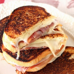A closeup of a Provolone Grilled Cheese Sandwich with melon and prosciutto.