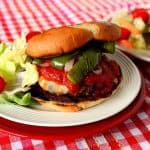 2 lbs. bulk Italian Sausage ½ teaspoon black pepper 1 teaspoon salt 2 teaspoons garlic powder 1 teaspoon dried oregano 1 teaspoon dried basil 2 medium green peppers, seeded and sliced 1 medium sweet onion, peeled and sliced 1 tablespoon olive oil 1/2 teaspoon salt 8 slices mozzarella cheese 8 hamburger buns 4 tablespoons softened butter garlic powder to taste Prepared spaghetti sauce (your favorite brand), warmed in the microwave -Preheat grill (or grill pan) to medium/high. -In a large bowl, mix together (I used my hands) the sausage, pepper, garlic powder, oregano and basil. -Divide the meat mixture into 8 equal portions and shape each portion into burger patties. -Grill the patties on a preheated grill (or grill pan) for approximately 7-8 minutes per side (cover for half of the cooking time). -Meanwhile, in a grill basket (or a large stovetop skillet), season and cook the green peppers and onions with the salt and olive oil until they are slightly wilted and no longer crunchy. Stirring occasionally. -Place the cheese on the burgers and cook just until the cheese has melted. Remove from the grill and keep warm. -Spread the softened butter on both sides of the buns and season with garlic powder to taste. -Place the buns (butter side down) on the grill and cook until they're browned and lightly crispy. -Place a burger on a bun, top with prepared warmed sauce, and the green pepper and onions. -Serve hot.