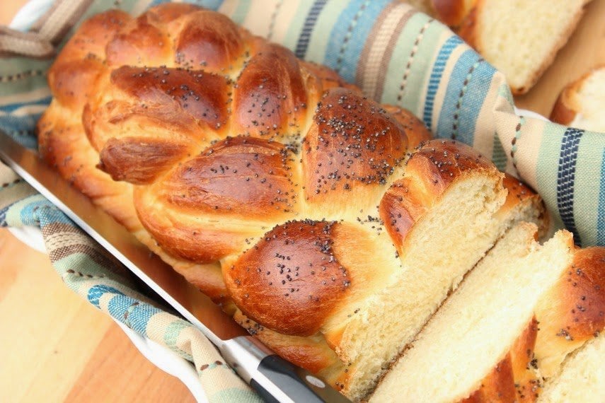 Braided Challah Bread Braided Challah Bread in a basket with a knife.