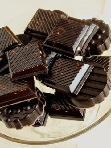 A glass plate filled with Dark Chocolate Almond Candy