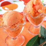 Two glass parfait dishes filled with Peach Sorbet with Sage.