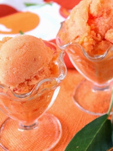 Two glass parfait dishes filled with Peach Sorbet with Sage.