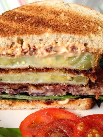 A B, L, and Fried Green T Sandwich that's been cut in half.