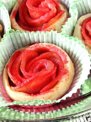 A closeup of some Apple Pie Roses on a silver platter along with paper cup liners.