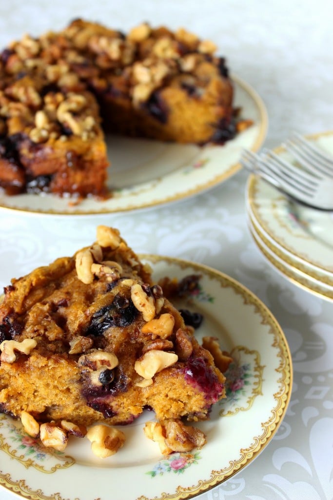 A vertical photo of a slice of Slow Cooker Pumpkin Blueberry Cake on a china plate.