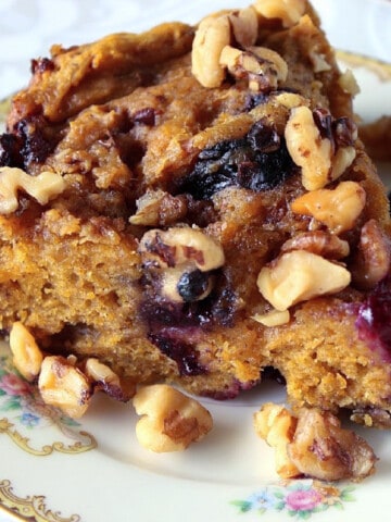 A slice of Slow Cooker Pumpkin Blueberry Cake on a pretty plate.