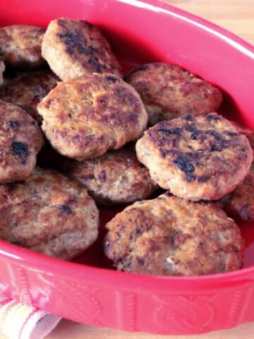 A bunch of Turkey Breakfast Sausage in a red dish.