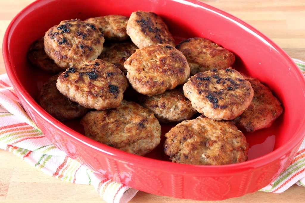 Homemade Turkey Breakfast Sausages in a oval red casserole dish.