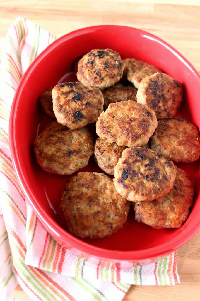 An overhead photo of Homemade Turkey Breakfast Sausages in a red casserole dish.