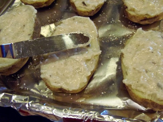 An offset spatula leveling off a twice baked potato grave.