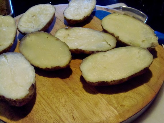 Baked potatoes that have been cut in half.