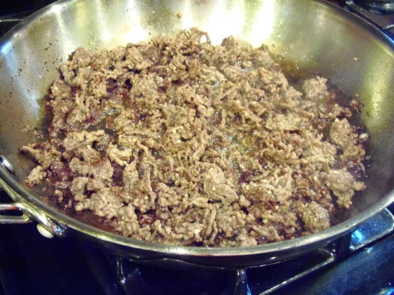 Browned ground beef in a skillet.