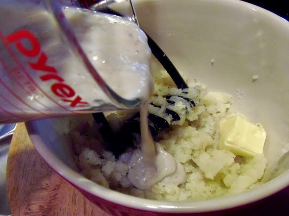 Cream of mushroom soup being added to mashed potatoes.