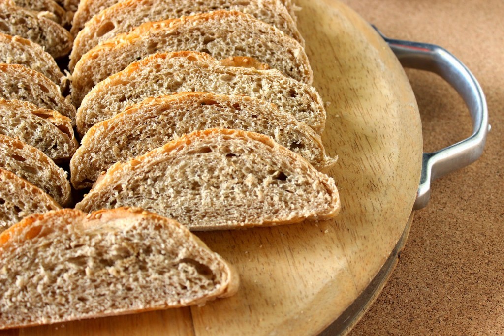 Closeup photo of whole wheat bread slices on a cutting board.