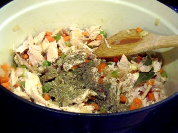 Diced chicken and seasonings in a soup pot.