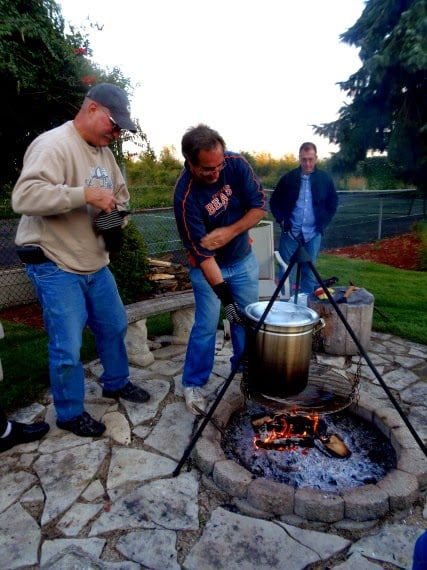 People cooking a low country boil over a firepit.