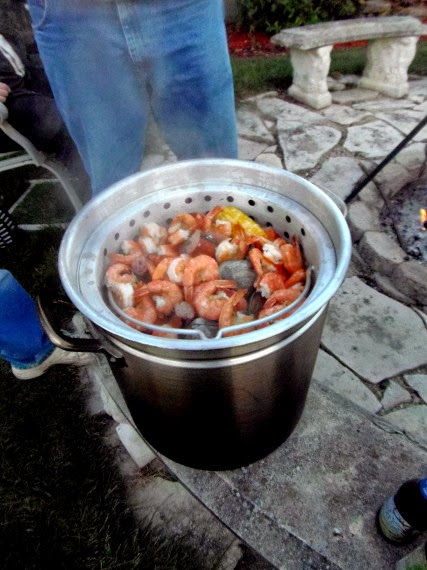 Low country seafood boil pot filled with shrimp, clams, sausage, corn, and potatoes.