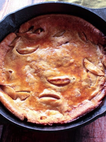 An Apple Dutch Baby Pancake in a cast iron skillet.