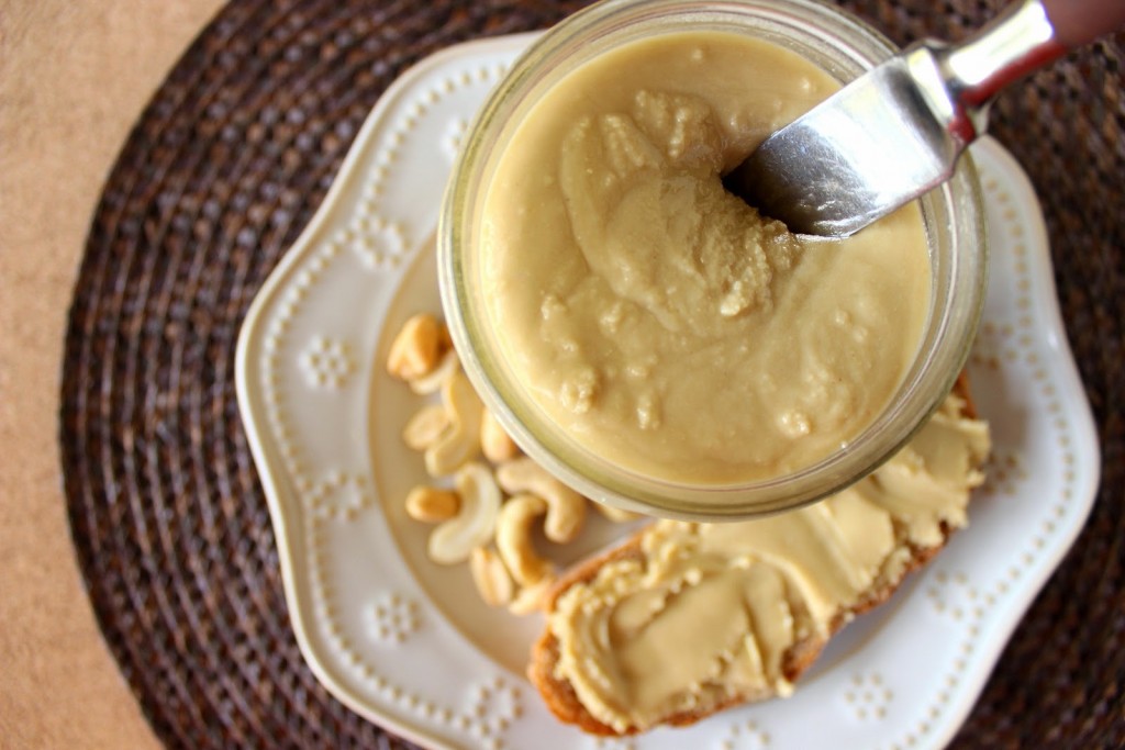 Overhead photo of the inside of a jar of Healthy Honey Cashew Peanut Butter with a knife.