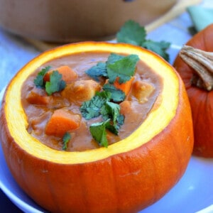 Chicken and Pumpkin Stew served in a mini pumpkin with parsley on top.