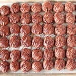A baking sheet filled with Double Chocolate Creme de Menthe Cookies with a chocolate drizzle over top.