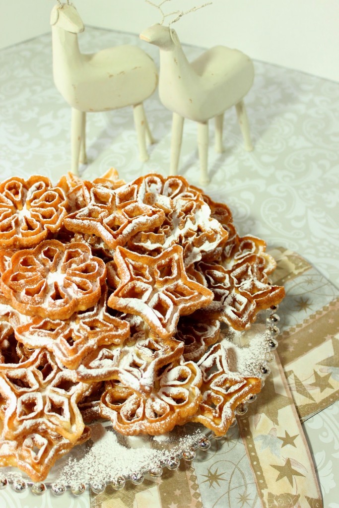 Part of the fun of eating a Rosette Snowflake Cookie is the dusting of confectioners sugar that will snow down the front of your shirt as you crunch into these crispy little holiday treats. There's no way around it so just give in and let it snow! - kudoskitchenbyrenee.com Fried Snowflake Rosette Cookies with Confectioners Sugar Dusting - kudoskitchenbyrenee.com