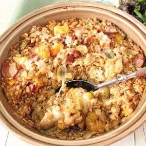 A round casserole dish filled with Baked Farro Casserole with Brussels sprouts and bacon.