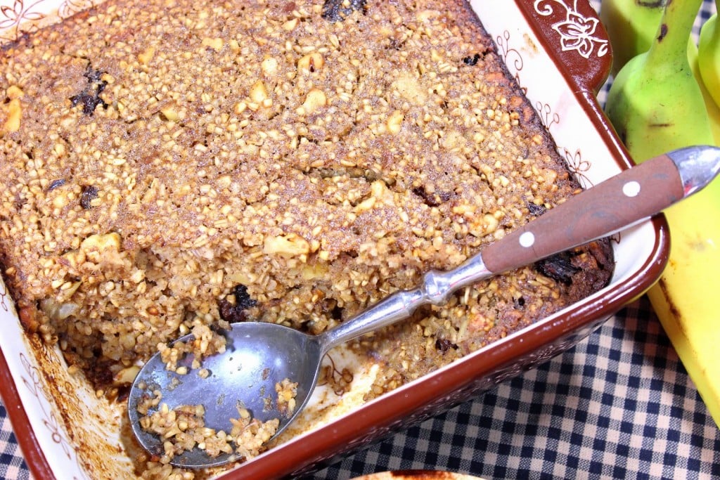 Overhead picture of baked steel cut oatmeal in a baking dish with a spoon.