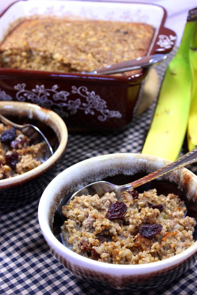 Long vertical image of baked steel cut oatmeal in brown bowls with spoons and bananas in the background.