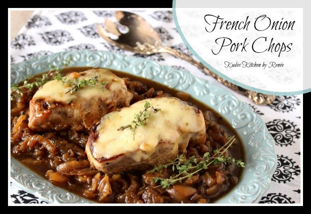 Boneless French Onion Pork Chops Two juicy brown pork chops on a pretty blue scalloped plate with caramelized onion, melted cheese, and fresh thyme sprigs.