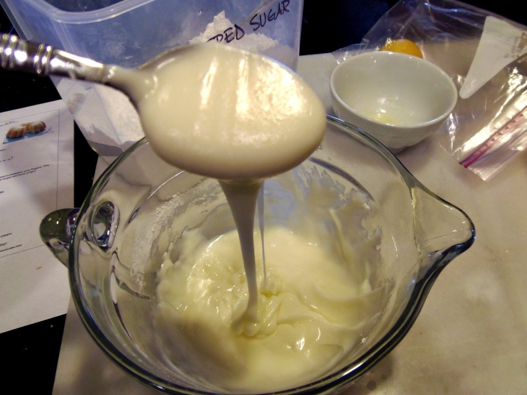 A glaze for a Bundt cake with a spoon.