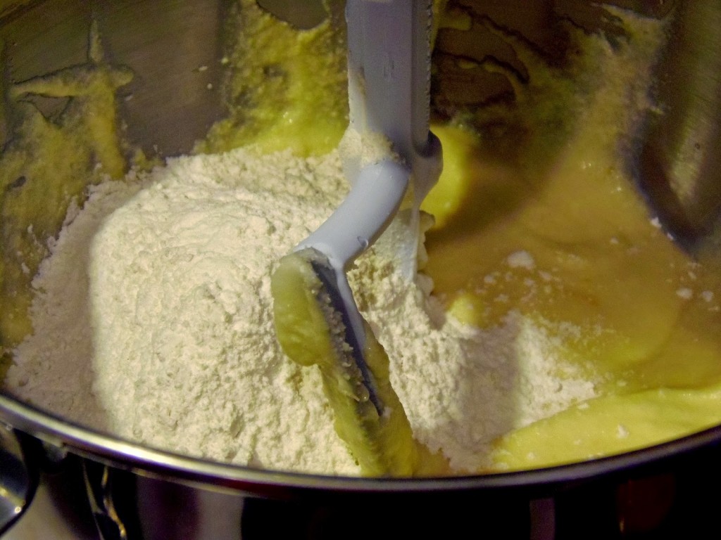 Flour added to a batter in a stand mixer.