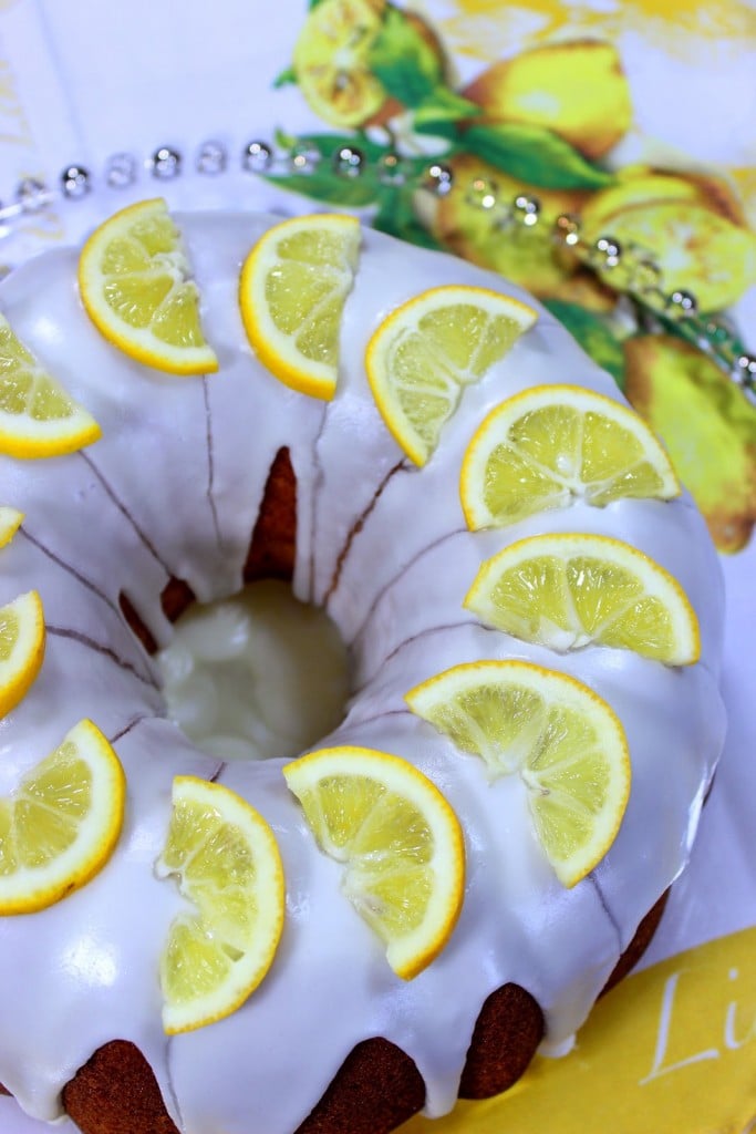A glazed Meyer Lemon Poundcake with lemon slices on top.