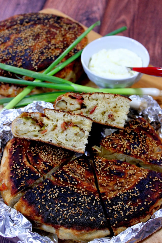 A closeup vertical image of the inside of Chinese Bing Bread with Bacon, scallions, and sesame seeds.