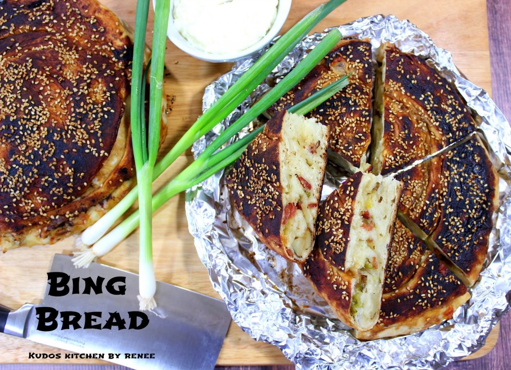 Overhead photo of Chinese Bing Bread in foil with scallions and a cleaver.