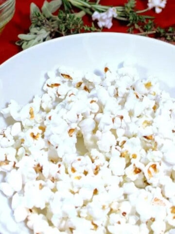 A large bowl filled with Herb Butter and Cheese Popcorn.