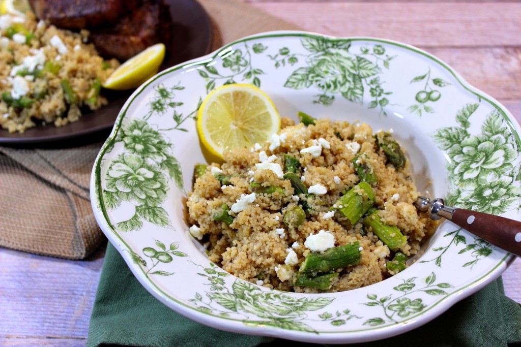 A pretty green and white bowl filled with Couscous Salad with Feta and Asparagus.