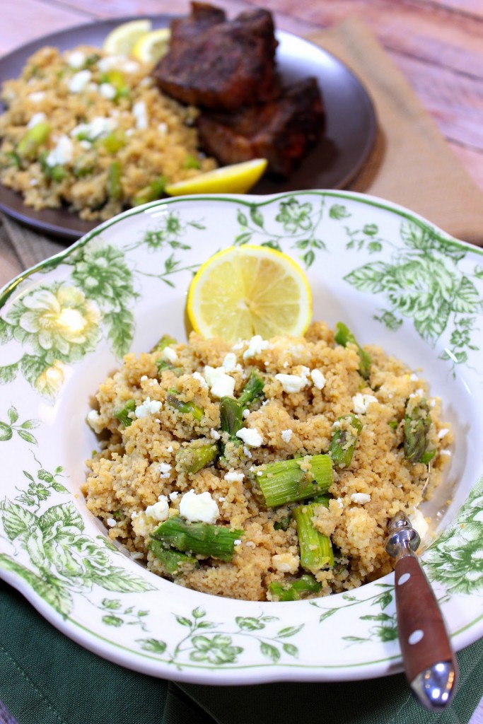 A pretty green and white bowl filled with Couscous Salad with Feta and Asparagus.