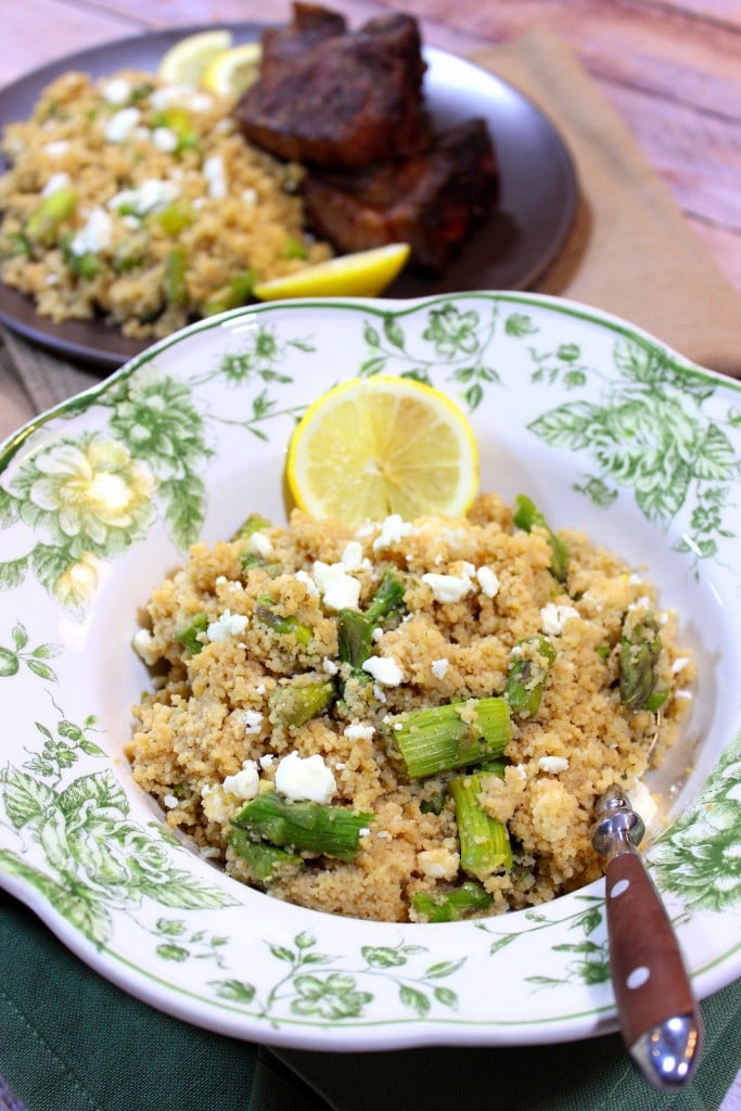 A pretty green and white bowl filled with Couscous Salad with Feta and Asparagus.