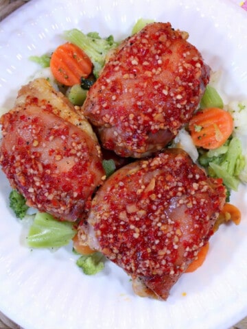 An overhead photo of Maple Garlic Chicken on a white plate with vegetables.